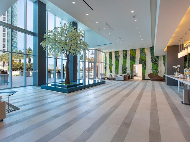 851 NE 1st Ave Unit Ph5011, Miami, FL 33132 - lobby featuring a wall of windows, a towering ceiling, and recessed lighting