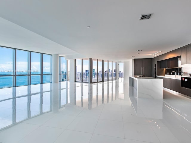 851 NE 1st Ave Unit Ph5011, Miami, FL 33132 - interior space featuring modern cabinets, a center island, expansive windows, open floor plan, and a sink