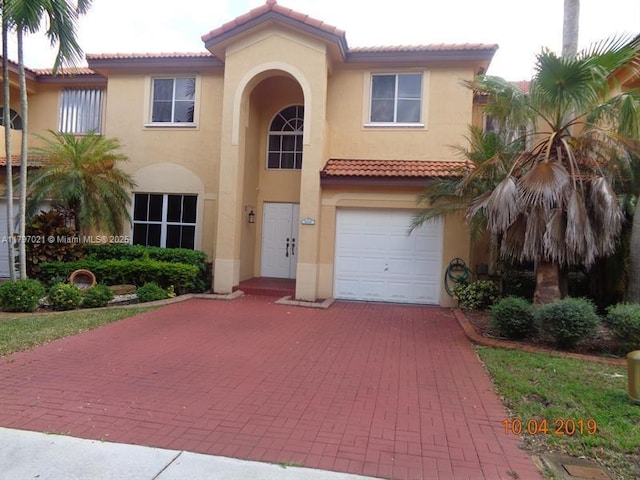 238 Magnolia Ave, Davie, FL 33325 - mediterranean / spanish-style home with stucco siding, decorative driveway, and a tile roof