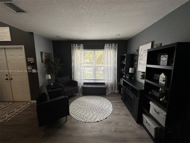 238 Magnolia Ave, Davie, FL 33325 - living area with light wood finished floors and a textured ceiling