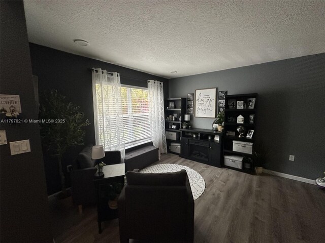 238 Magnolia Ave, Davie, FL 33325 - living room featuring wood finished floors, a textured ceiling, and baseboards