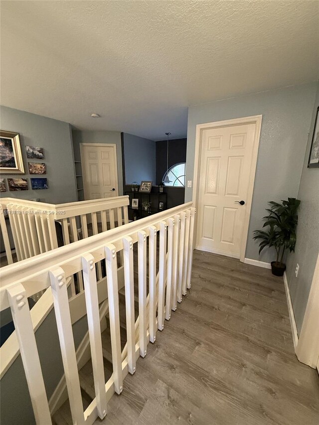 238 Magnolia Ave, Davie, FL 33325 - stairway with wood finished floors, baseboards, and a textured ceiling