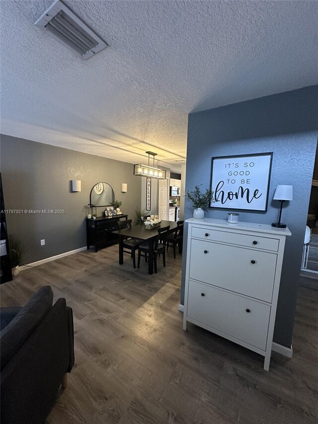 238 Magnolia Ave, Davie, FL 33325 - living room featuring a textured ceiling, dark wood-type flooring, and baseboards