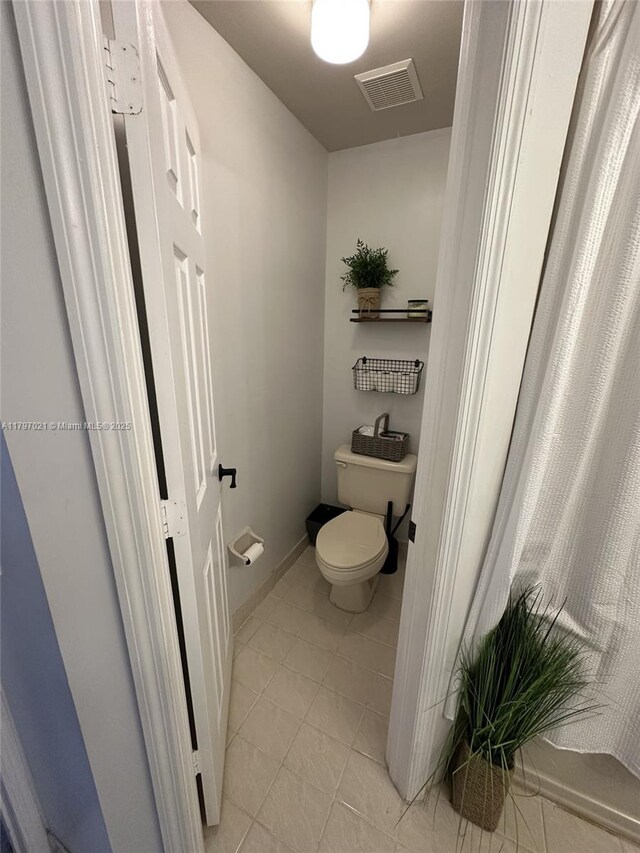 238 Magnolia Ave, Davie, FL 33325 - bathroom with toilet, tile patterned flooring, and baseboards