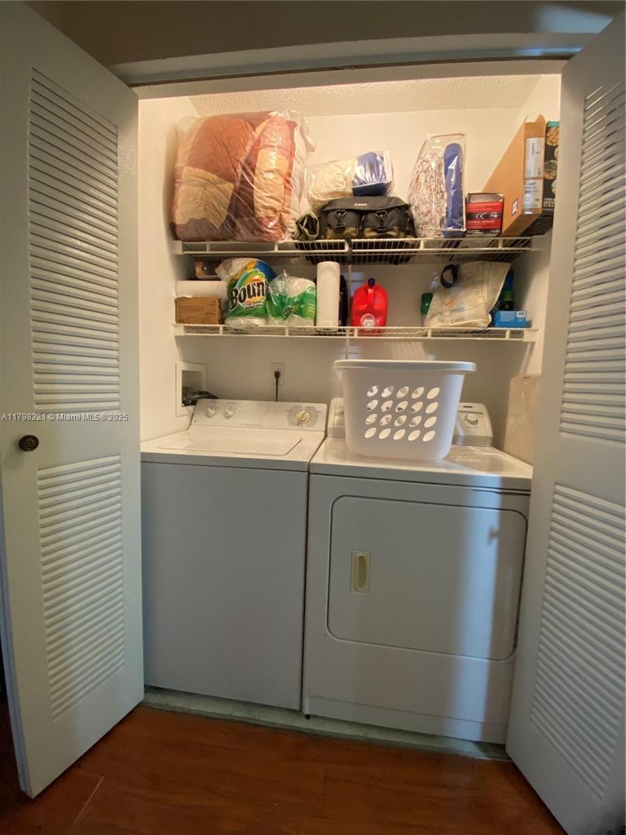4460 NW 107th Ave Unit 303-8, Doral, FL 33178 - washroom featuring separate washer and dryer and wood finished floors