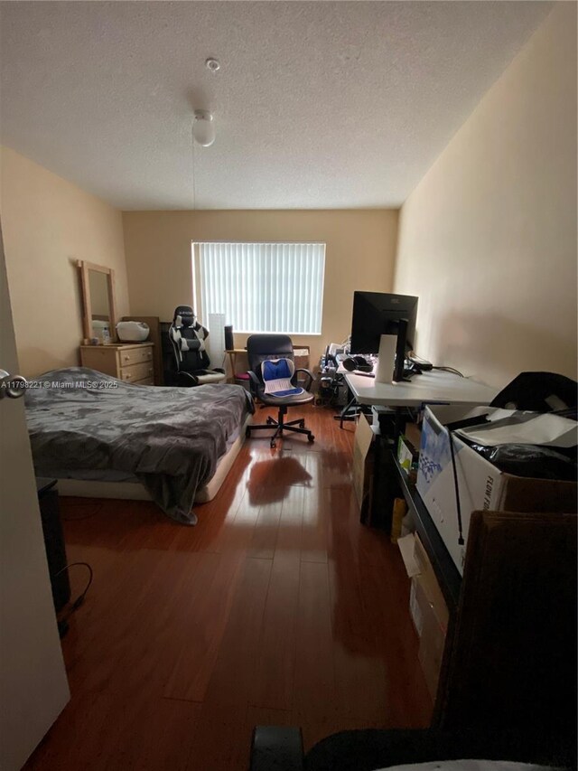 4460 NW 107th Ave Unit 303-8, Doral, FL 33178 - bedroom featuring hardwood / wood-style floors, a textured ceiling, and an office area