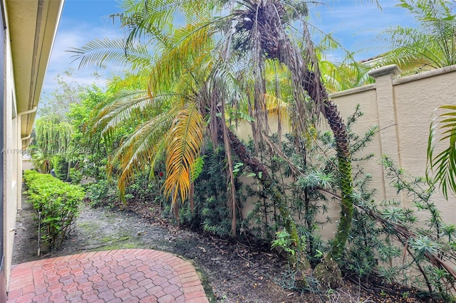 view of yard featuring fence and a patio