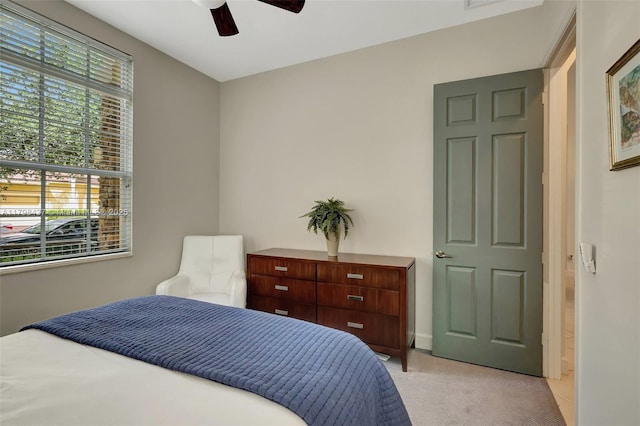 bedroom featuring light colored carpet and ceiling fan