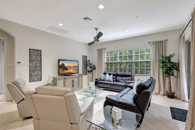 living room featuring ceiling fan, light tile patterned flooring, arched walkways, and recessed lighting