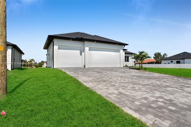1212 NW 35th Pl, Cape Coral, FL 33993 - view of side of property featuring decorative driveway, a garage, and stucco siding