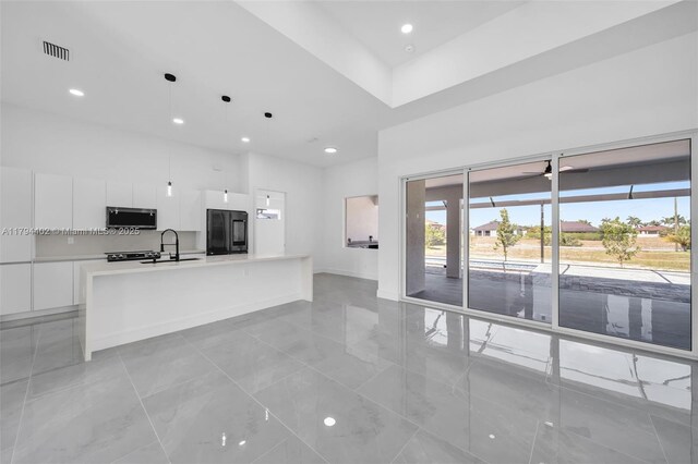 1212 NW 35th Pl, Cape Coral, FL 33993 - unfurnished living room with a towering ceiling, recessed lighting, a sink, a ceiling fan, and light tile patterned floors