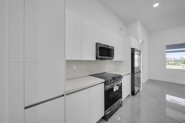 1212 NW 35th Pl, Cape Coral, FL 33993 - kitchen featuring stainless steel microwave, black range with electric cooktop, white cabinets, modern cabinets, and recessed lighting