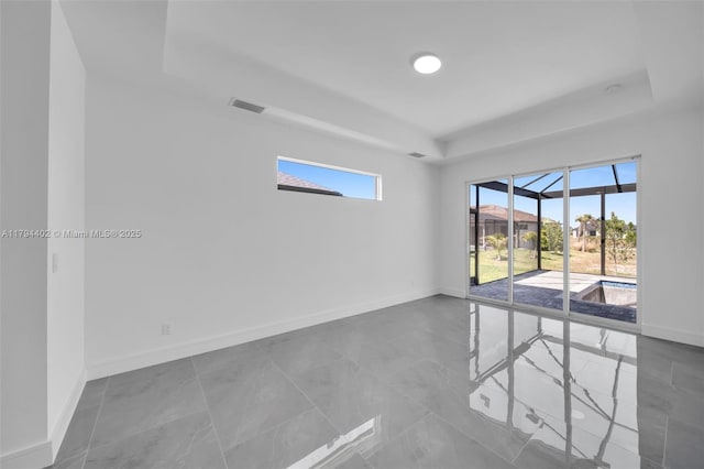 1212 NW 35th Pl, Cape Coral, FL 33993 - spare room with a raised ceiling, a sunroom, and baseboards