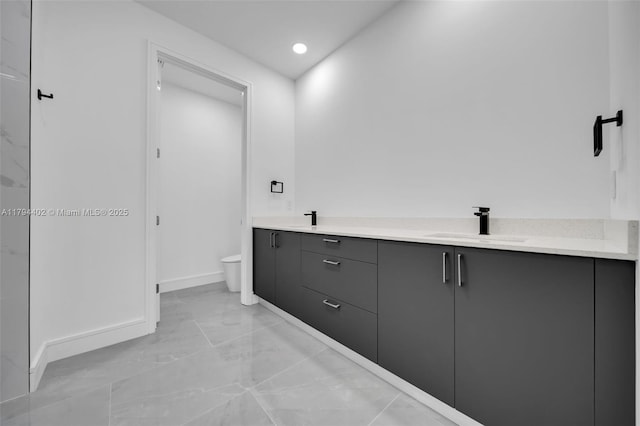 1212 NW 35th Pl, Cape Coral, FL 33993 - full bathroom with marble look tile flooring, toilet, baseboards, double vanity, and recessed lighting