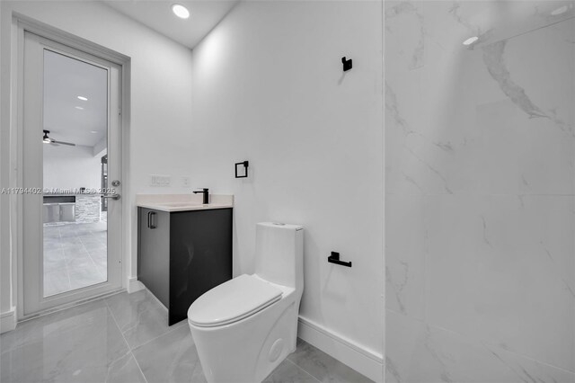 1212 NW 35th Pl, Cape Coral, FL 33993 - bathroom with toilet, marble look tiles, baseboards, and vanity