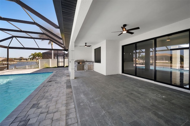 1212 NW 35th Pl, Cape Coral, FL 33993 - outdoor pool featuring exterior kitchen, a ceiling fan, a patio area, and glass enclosure