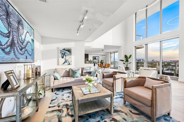1180 N Federal Hwy Unit 1407, Fort Lauderdale, FL 33304 - living room featuring wood finished floors, high vaulted ceiling, and track lighting