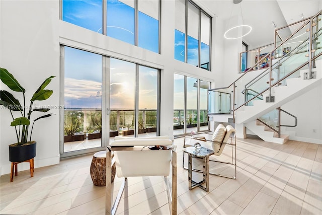 1180 N Federal Hwy Unit 1407, Fort Lauderdale, FL 33304 - tiled living room with plenty of natural light, a towering ceiling, stairway, and baseboards