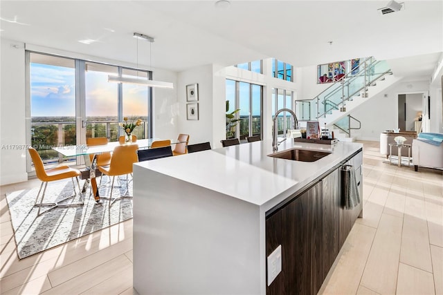 1180 N Federal Hwy Unit 1407, Fort Lauderdale, FL 33304 - kitchen featuring a sink, modern cabinets, healthy amount of natural light, a kitchen island with sink, and floor to ceiling windows