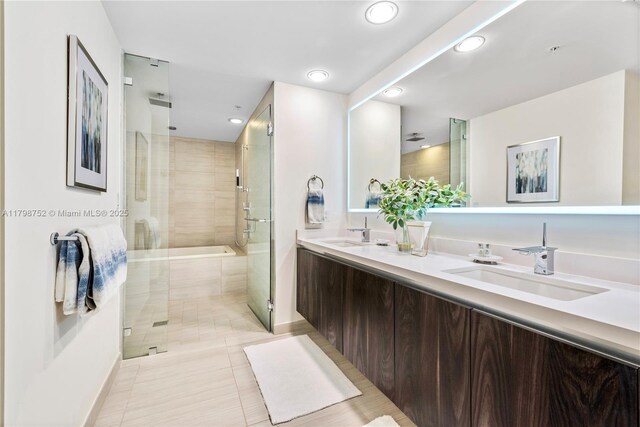 1180 N Federal Hwy Unit 1407, Fort Lauderdale, FL 33304 - bathroom featuring tiled shower, recessed lighting, a tub to relax in, double vanity, and tile patterned floors