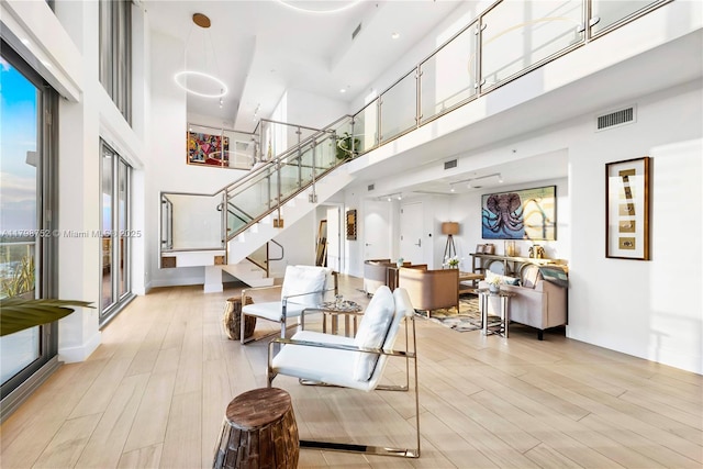 1180 N Federal Hwy Unit 1407, Fort Lauderdale, FL 33304 - living area featuring a high ceiling, light wood-style floors, and stairs