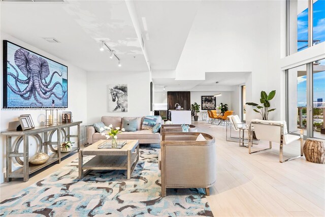 1180 N Federal Hwy Unit 1407, Fort Lauderdale, FL 33304 - living room featuring wood finished floors and rail lighting