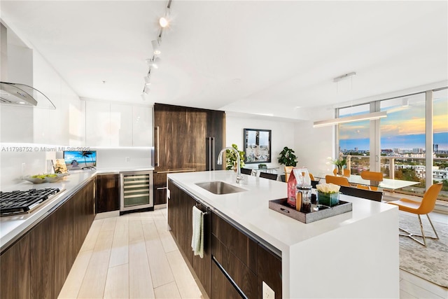 1180 N Federal Hwy Unit 1407, Fort Lauderdale, FL 33304 - kitchen with modern cabinets, beverage cooler, a sink, and stainless steel gas cooktop