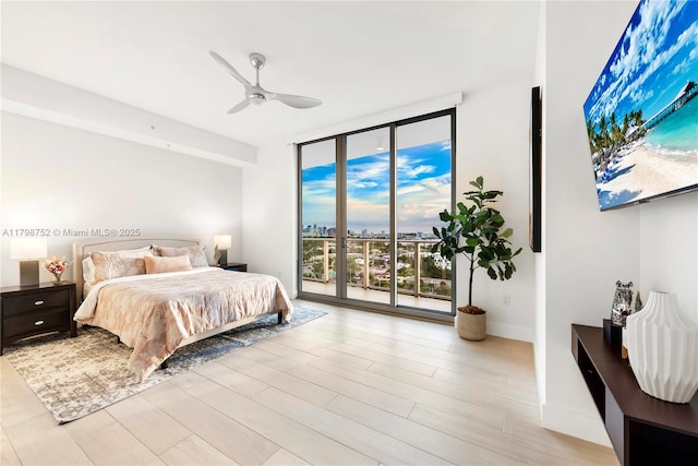 1180 N Federal Hwy Unit 1407, Fort Lauderdale, FL 33304 - bedroom with a wall of windows, access to outside, a ceiling fan, and light wood-type flooring