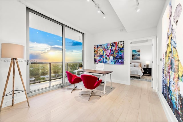 1180 N Federal Hwy Unit 1407, Fort Lauderdale, FL 33304 - dining area with rail lighting, a wall of windows, wood finished floors, and baseboards