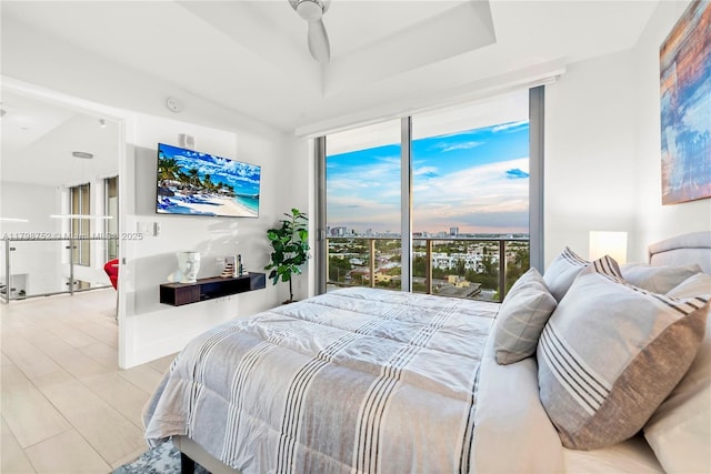 1180 N Federal Hwy Unit 1407, Fort Lauderdale, FL 33304 - bedroom featuring expansive windows, a tray ceiling, and access to exterior