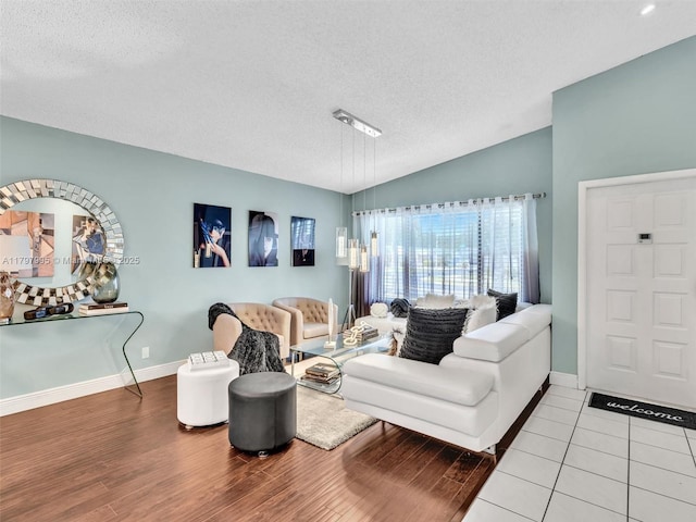5206 NW 99th Ave, Sunrise, FL 33351 - living room with a textured ceiling, wood finished floors, vaulted ceiling, and baseboards