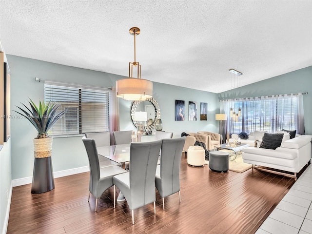5206 NW 99th Ave, Sunrise, FL 33351 - dining space featuring a textured ceiling, wood finished floors, and baseboards