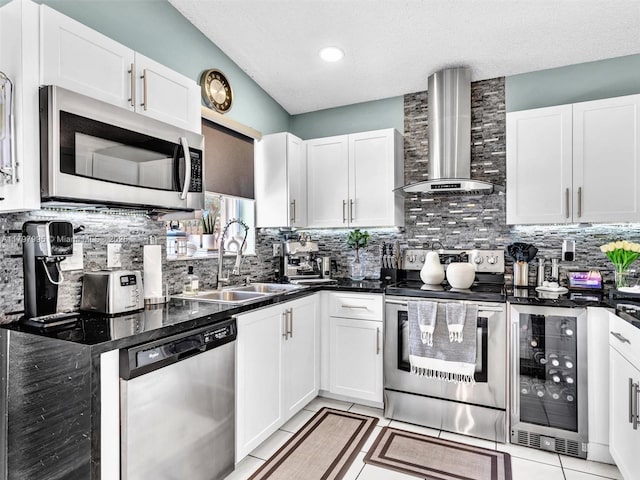 5206 NW 99th Ave, Sunrise, FL 33351 - kitchen featuring appliances with stainless steel finishes, wall chimney range hood, a sink, tasteful backsplash, and a textured ceiling