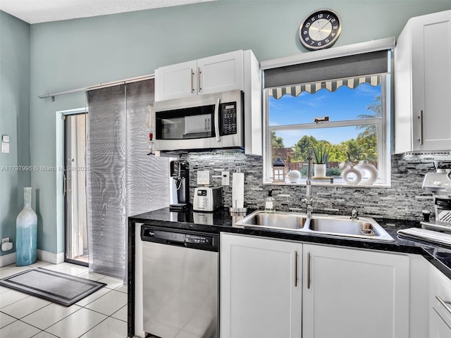 5206 NW 99th Ave, Sunrise, FL 33351 - kitchen with appliances with stainless steel finishes, dark countertops, a sink, and white cabinetry