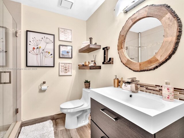 5206 NW 99th Ave, Sunrise, FL 33351 - full bathroom with a shower stall, toilet, wood finished floors, and baseboards