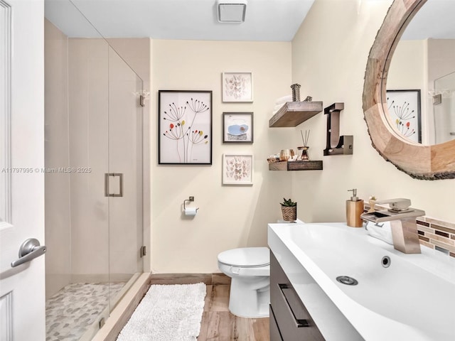 5206 NW 99th Ave, Sunrise, FL 33351 - full bathroom with a shower stall, toilet, vanity, wood finished floors, and baseboards