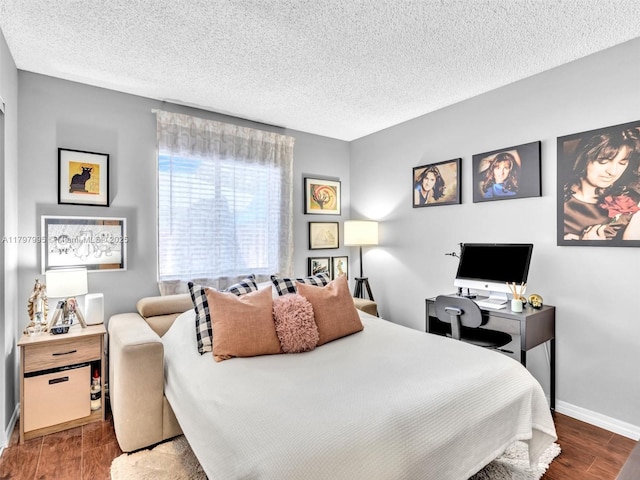 5206 NW 99th Ave, Sunrise, FL 33351 - bedroom featuring a textured ceiling, wood finished floors, baseboards, and a desk