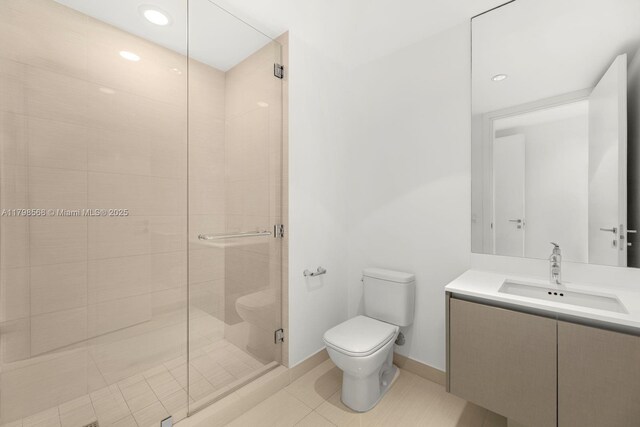 bathroom with toilet, a stall shower, vanity, recessed lighting, and tile patterned floors
