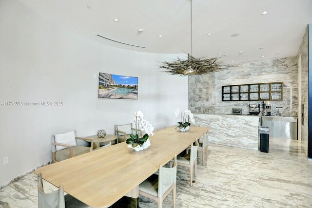 dining area with recessed lighting and marble finish flooring
