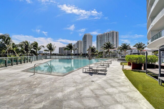 community pool featuring a patio and a city view