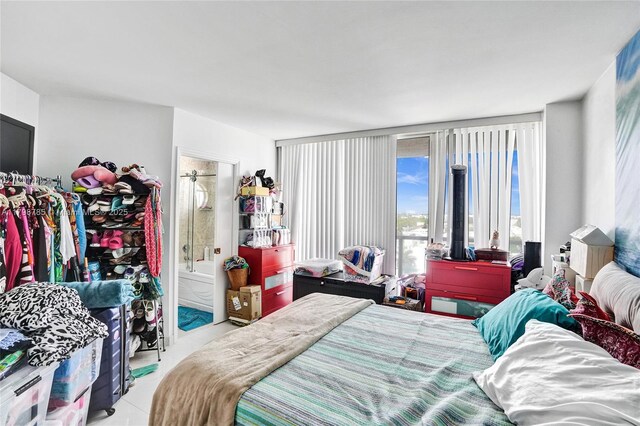 7330 Ocean Ter Unit 8-C, Miami Beach, FL 33141 - bedroom featuring ensuite bathroom and tile patterned flooring