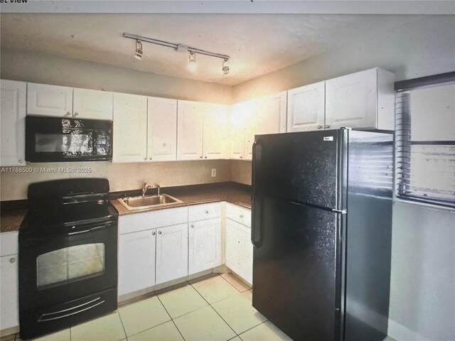 2641 SW 13th Ave, Fort Lauderdale, FL 33315 - kitchen with black appliances, a sink, white cabinetry, dark countertops, and light tile patterned flooring