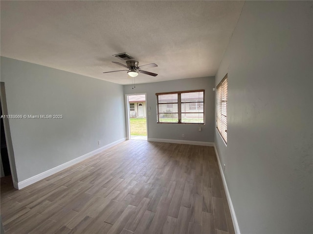 2641 SW 13th Ave, Fort Lauderdale, FL 33315 - spare room featuring wood finished floors, a ceiling fan, baseboards, and a textured ceiling