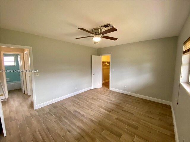 2641 SW 13th Ave, Fort Lauderdale, FL 33315 - unfurnished bedroom featuring baseboards, wood finished floors, and a ceiling fan
