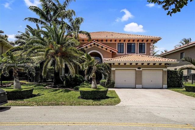 mediterranean / spanish-style house with a tiled roof, stucco siding, concrete driveway, and a garage