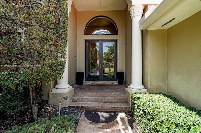 property entrance with french doors and stucco siding
