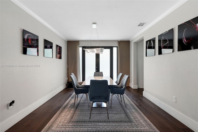 dining room with crown molding, baseboards, and dark wood-type flooring