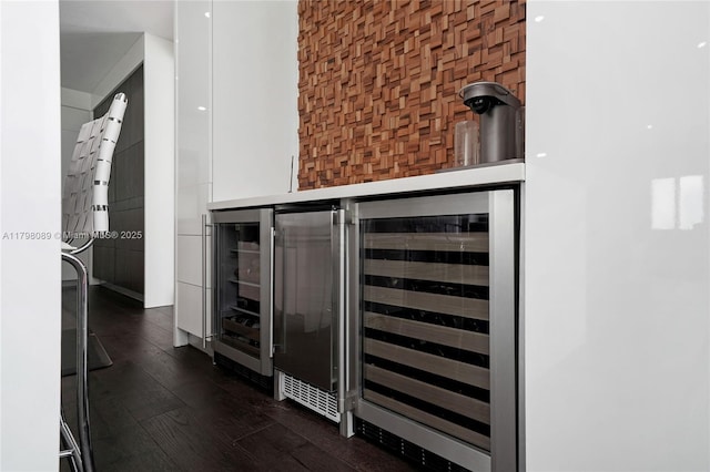 kitchen view of dark wood-style floors and beverage cooler
