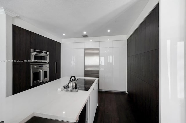 kitchen with modern cabinets, white cabinets, dark wood-style flooring, light countertops, and recessed lighting