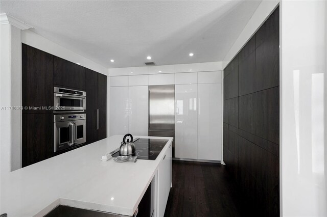 7567 SW 189th St, Cutler Bay, FL 33157 - kitchen with modern cabinets, white cabinets, dark wood-style flooring, light countertops, and recessed lighting